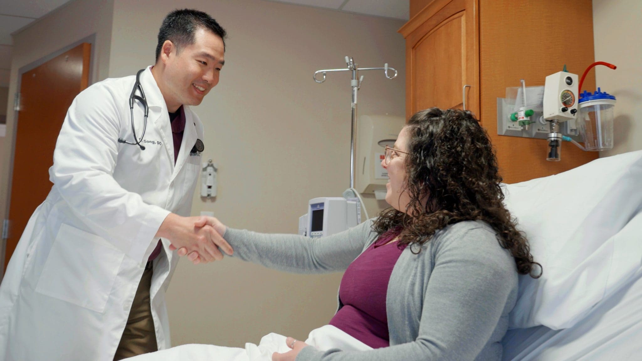 DrSong Shaking Hands with Patient Kyle Song, DO with patient at Virginia Gay Hospital