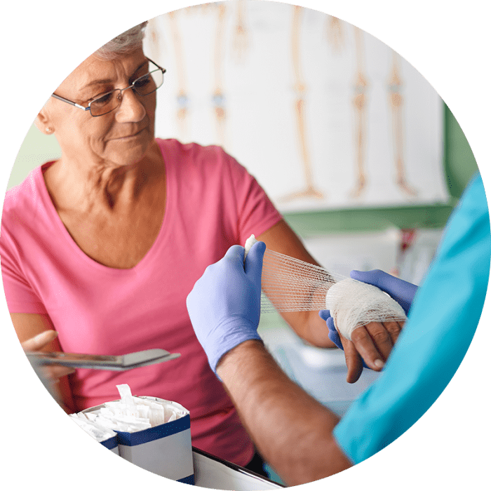 wound-care older woman getting her hand wrapped up