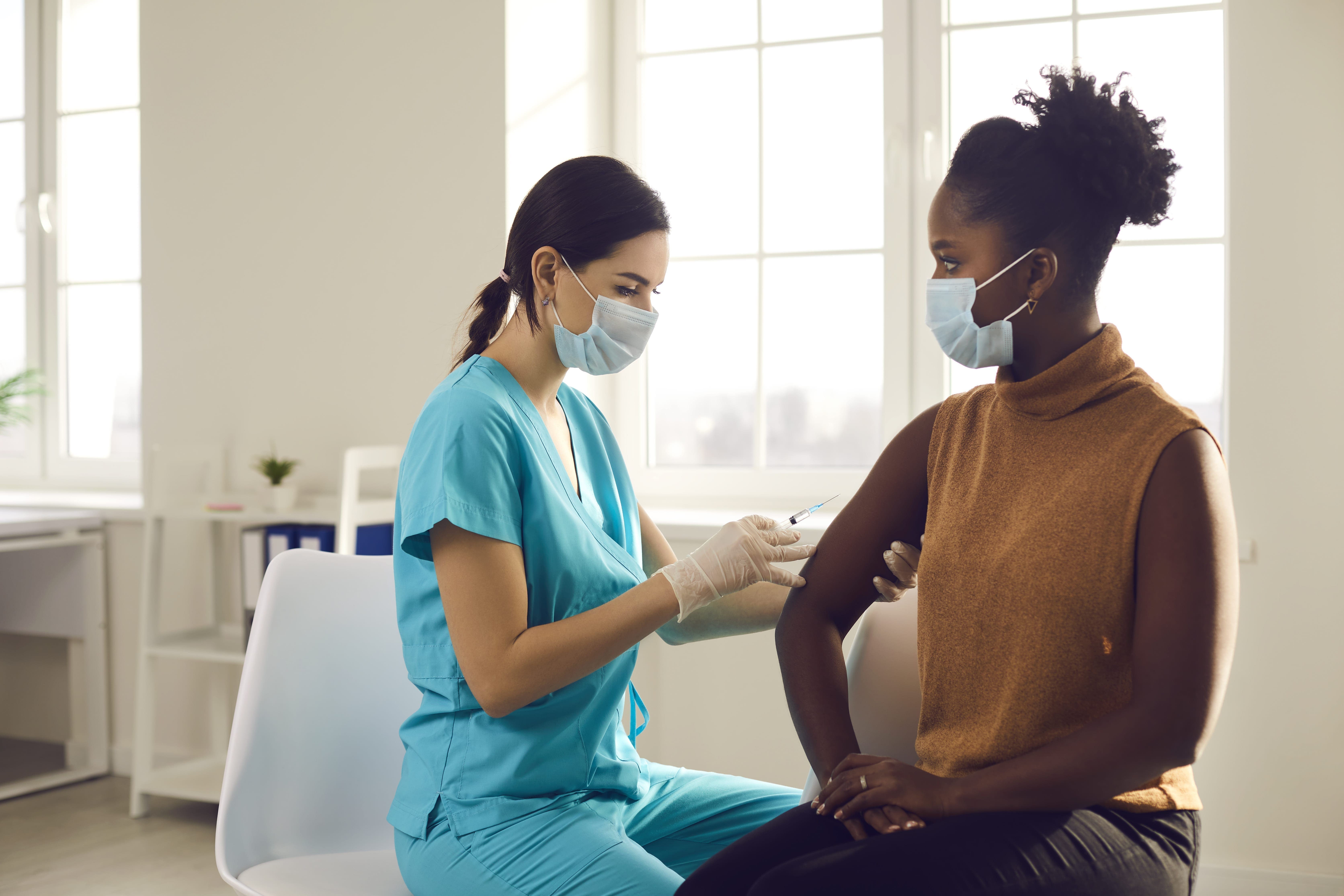 nurse giving patient a shot in arm