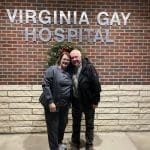 Lori Clark and man standing in front of Virginia Gay Hospital